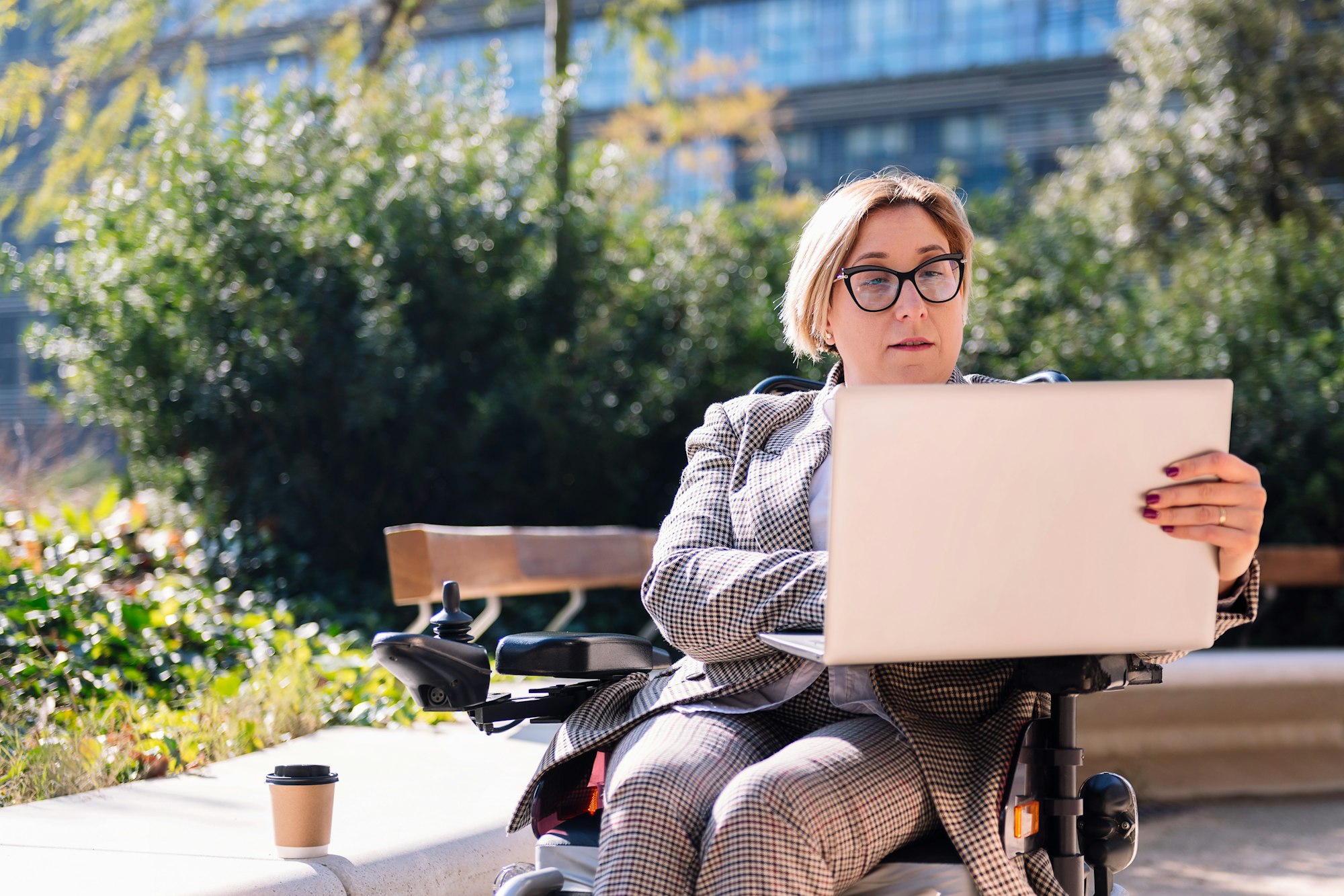businesswoman using wheelchair working with laptop